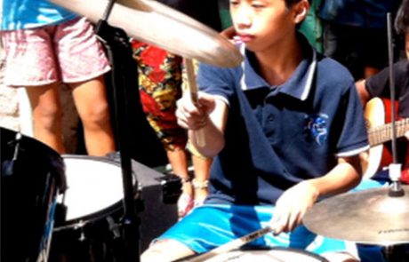 Stephano performing on the full drum set - the school in a cart - 2016