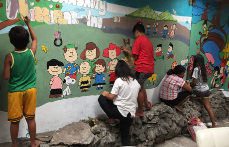 Painting the new mural - the school in a cart - 2019